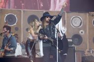 Billy Ray and Miley Cyrus performing together (Image via Getty)